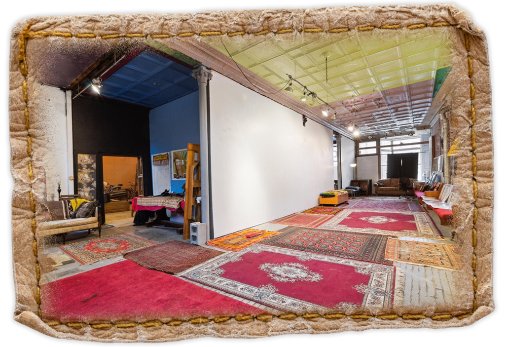 Inside of Fringe Central venue with red rugs and white walls ready for art